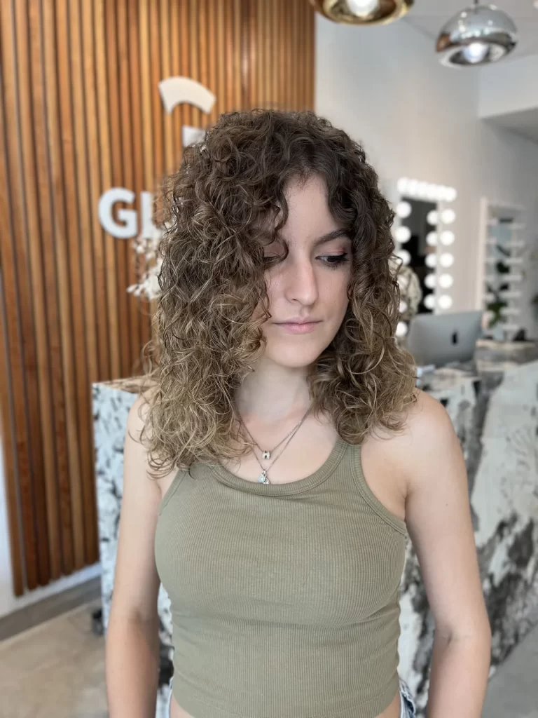 Client with voluminous defined curly hair at Gleam Hair Studio in South Miami