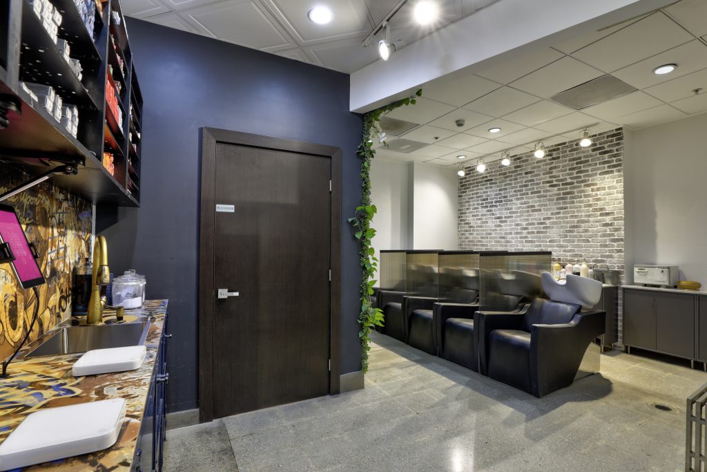 Hair color mixing counter and shampoo stations inside Gleam Hair Studio in South Miami